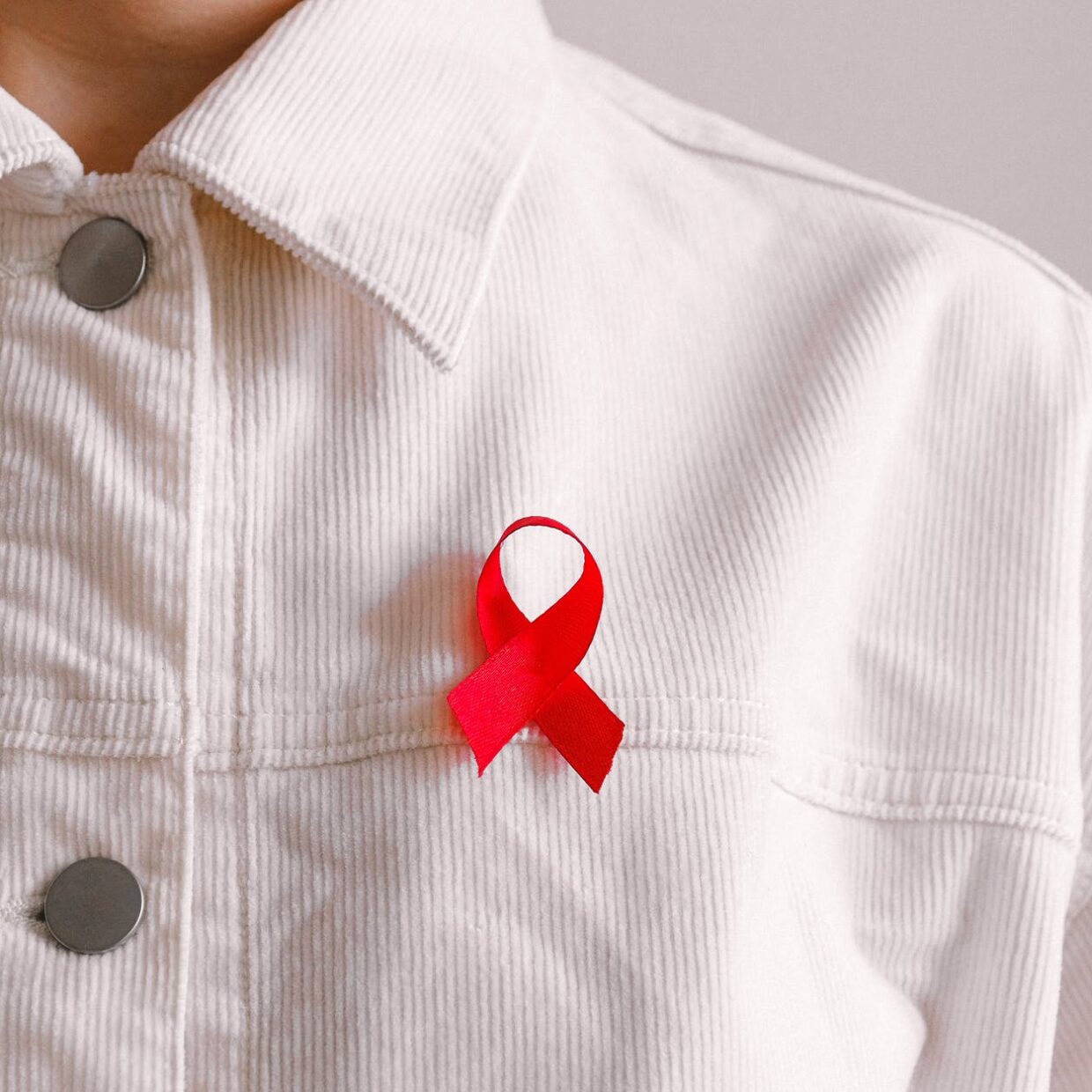 man wearing red ribbon